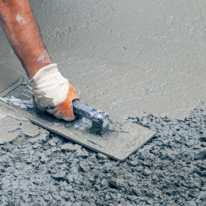 Construction worker giving concrete a finish