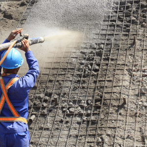 Shotcrete being pour over welded wire mesh