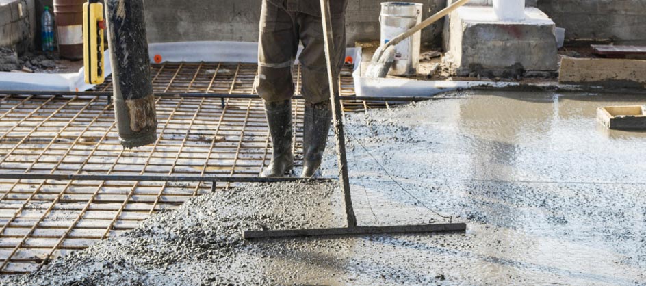 Concrete being applied with welded wire reinforcement